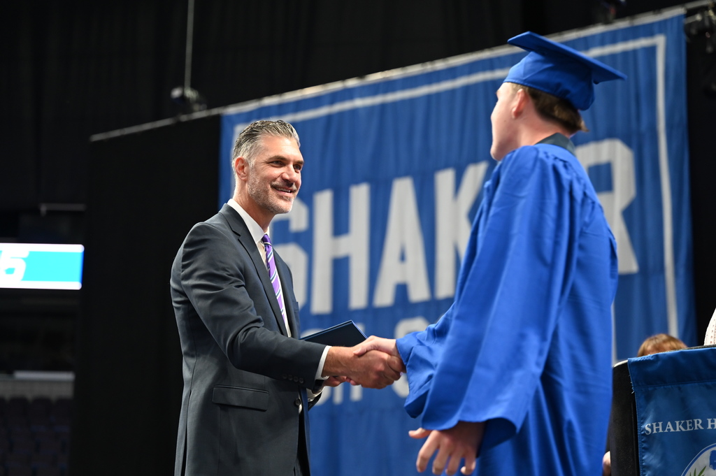 A Shaker High School senior shakes the principal's hand as he receives his diploma.
