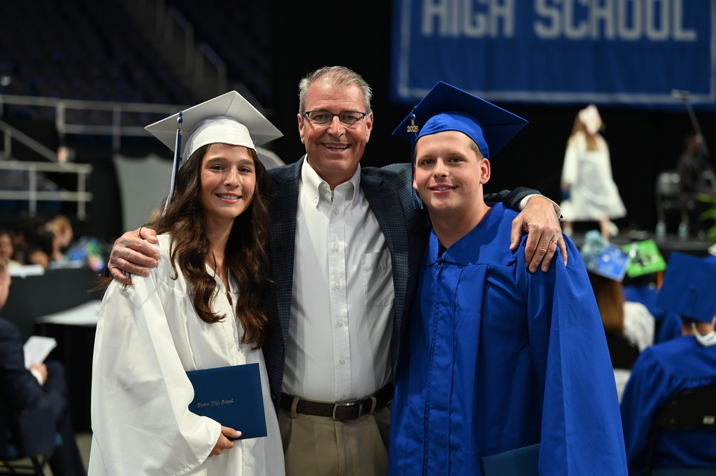Two Shaker graduates pose with a Shaker employee.