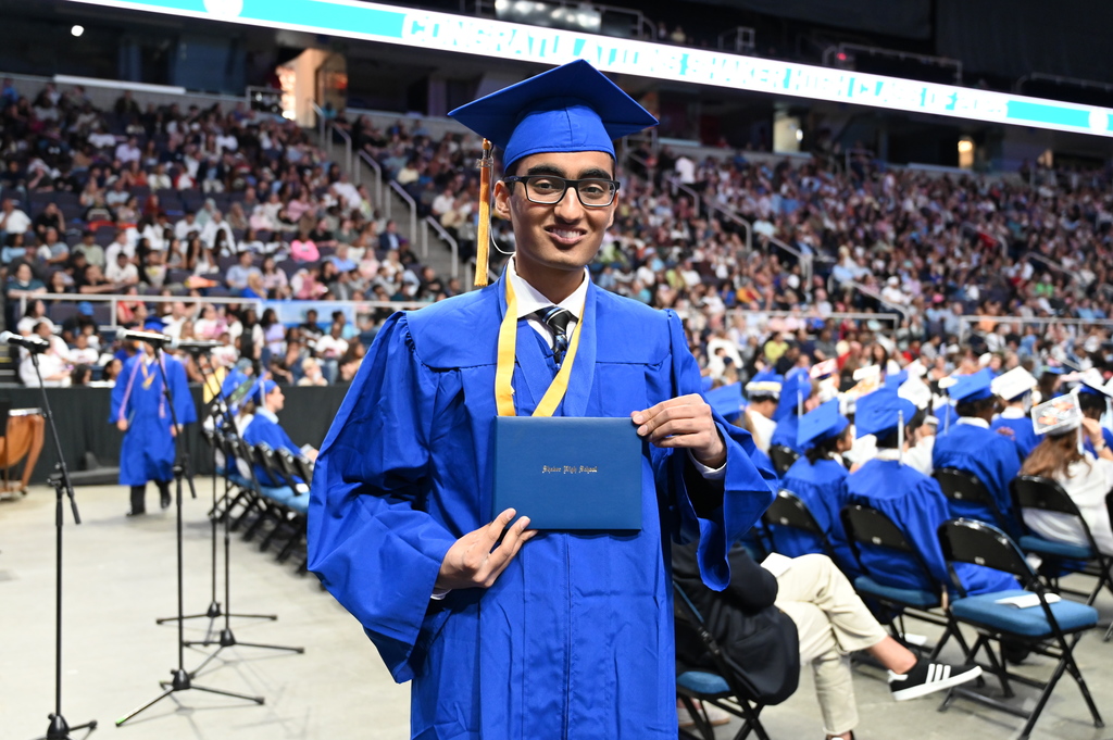 A Shaker graduate shows off his newly acquired diploma.
