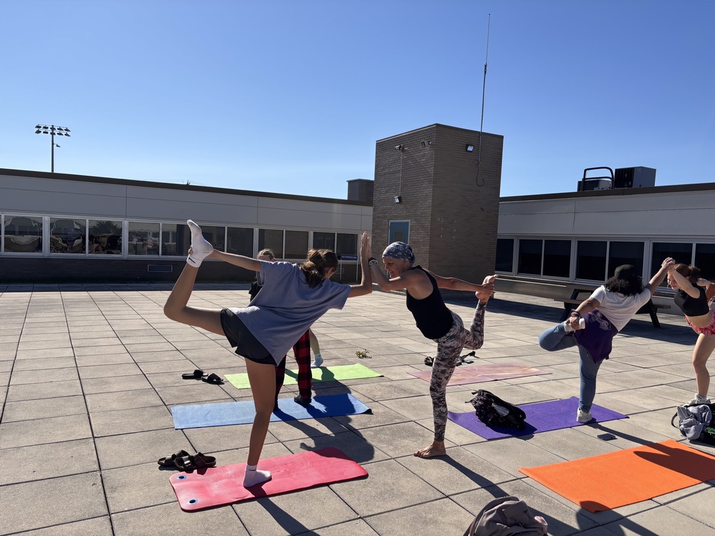 Ms. Dils doing morning yoga with students