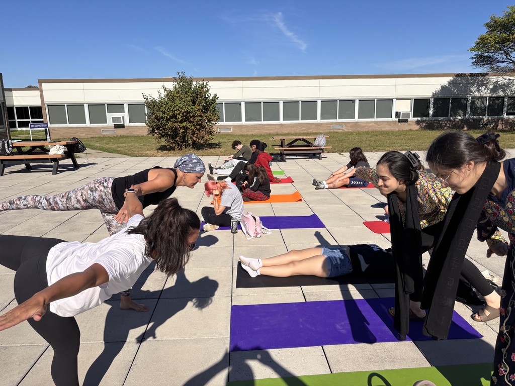 Ms. Dils teaching morning yoga to students