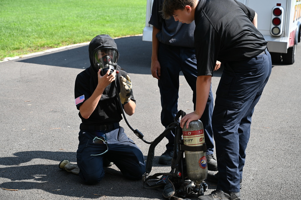 Boy putting on fire gear