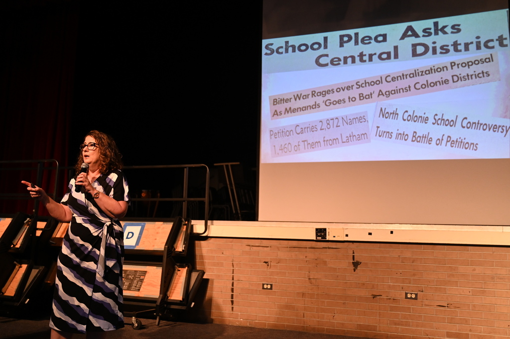 Superintendent Skeals showing newspaper clippings from 1949-1950, when North Colonie was being created