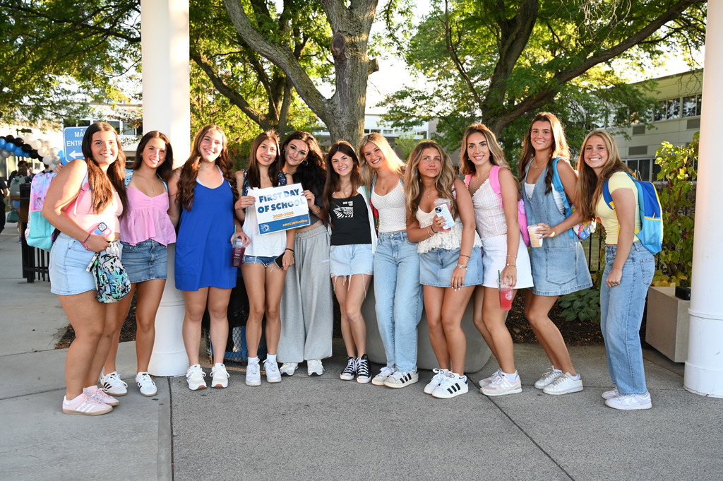 Students on the first day holding sign