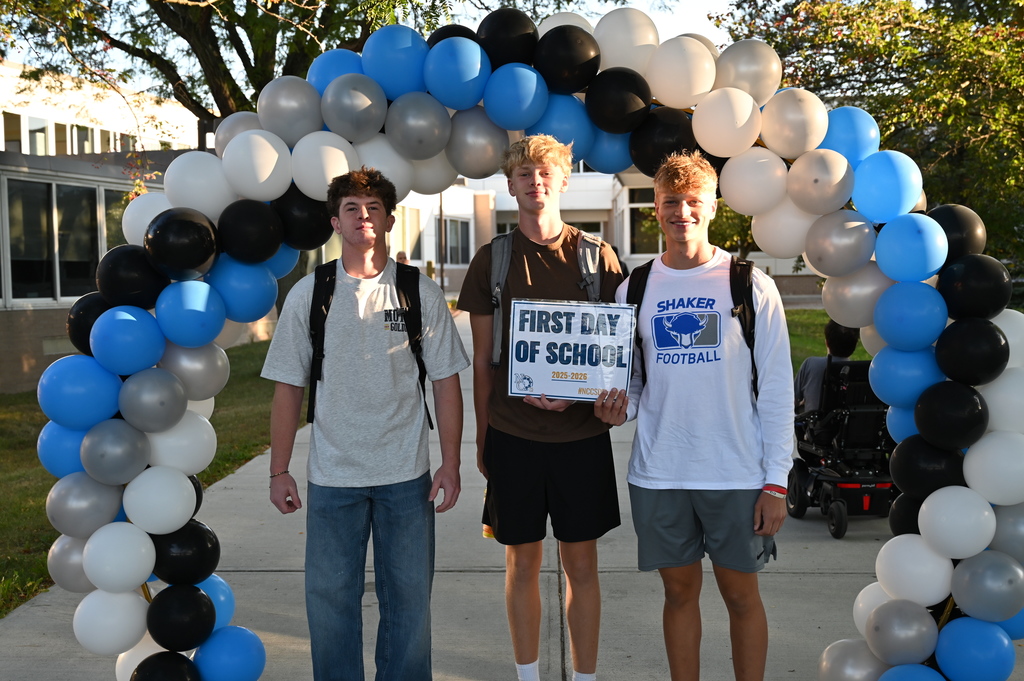 Students on the first day holding sign