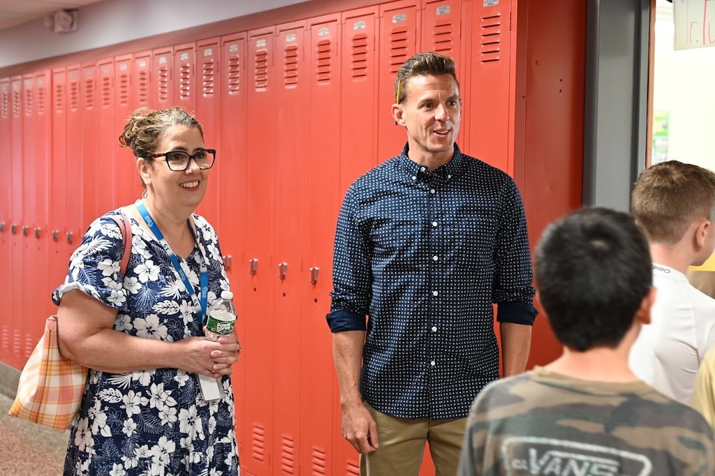Kathy and Shaker Middle School teacher welcoming students into classroom