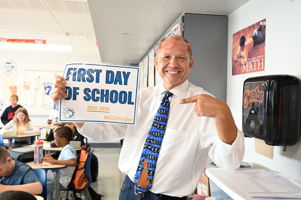 Shaker Middle School Teacher with first day sign.