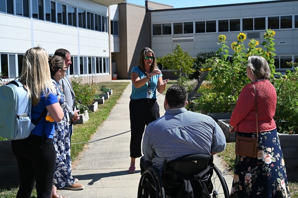 NYSED members and North Colonie faculty conversing at the SHS garden.