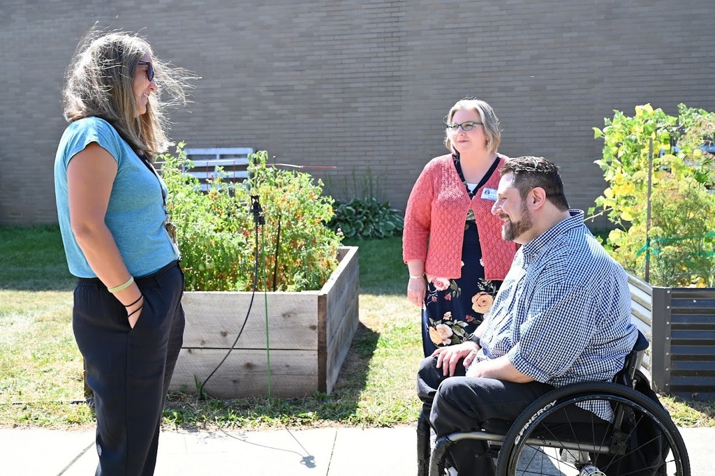 NYSED member conversing at the SHS garden.