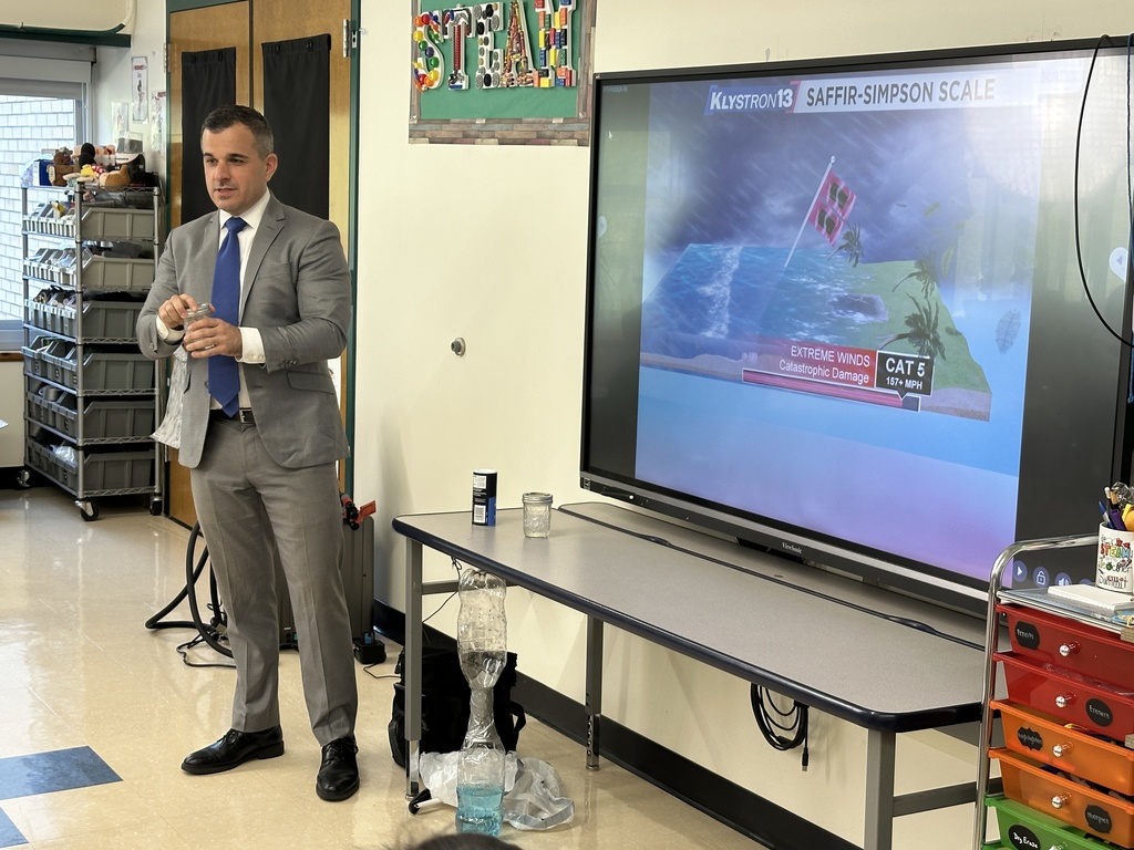 Chris Gilson holds a jar of ice as he explains frost as part of his presentation.