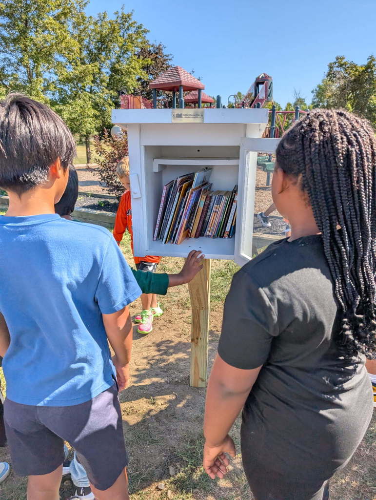 Students look on at the books in the Little Free Library at Boght Hills.