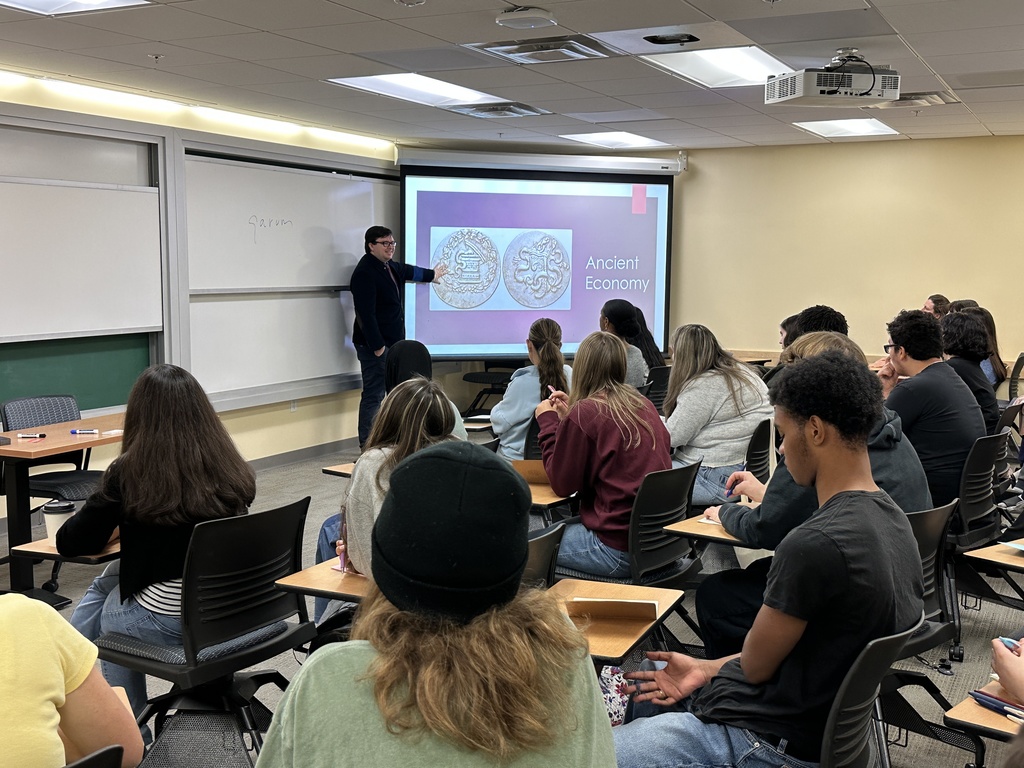 Professor Gregory Callahan presents to a room full of Shaker High students.