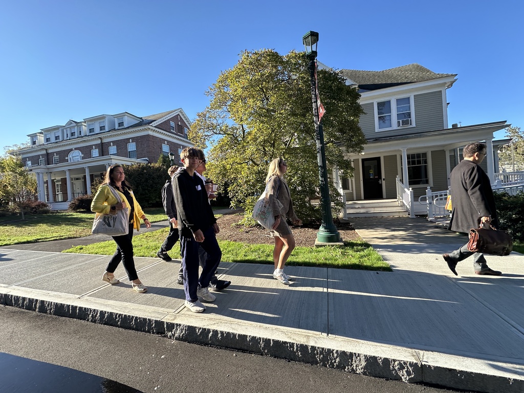 Shaker students and faculty walk on the sidewalk of the Union campus.