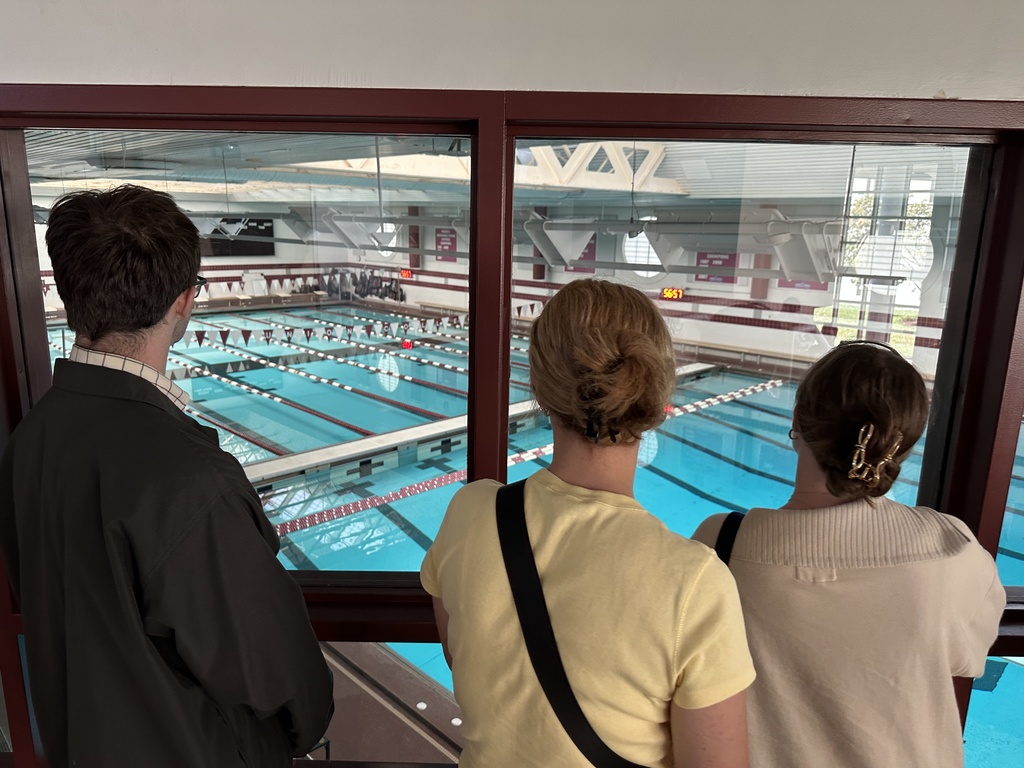 Students peer through the windows of the Olympic sized swimming pool on the Union campus.
