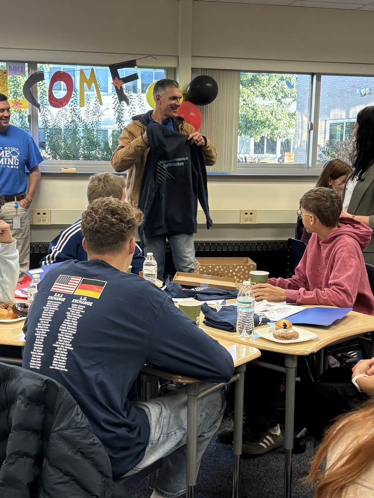 German exchange students and teacher present Mr. Puccioni with a sweatshirt from their school