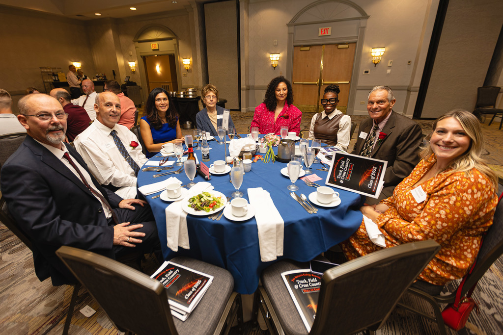 Eight people sitting around a dinner table.