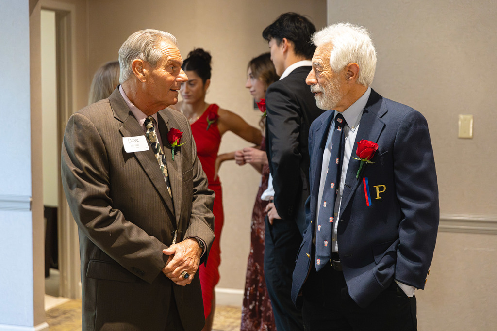 Shaker alum and former Athletic Director Dave Herman speaks with another gentleman at the ceremony.