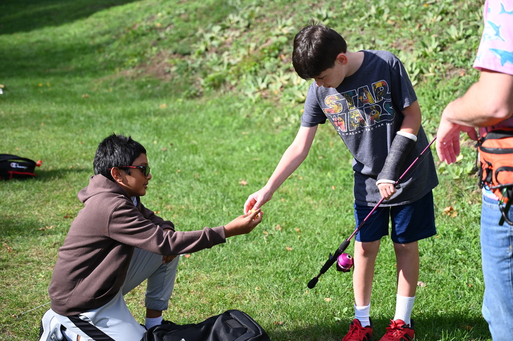 SMS student helps fellow student by offering a fishing lure