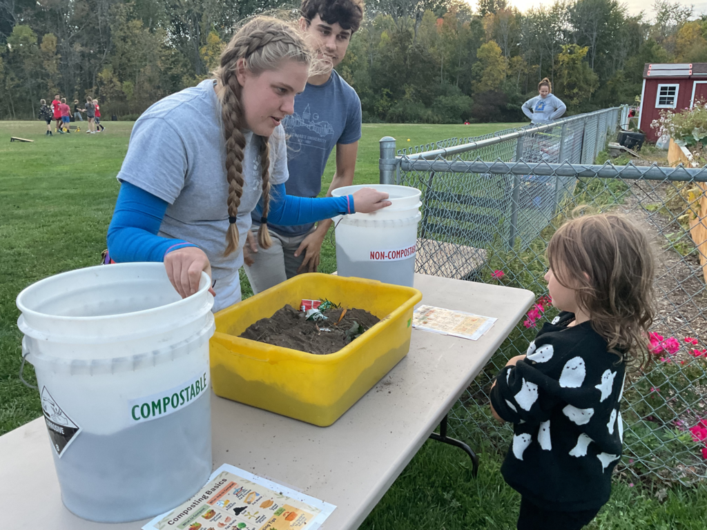 A young child learns the difference between compostable and non-compostable waste.