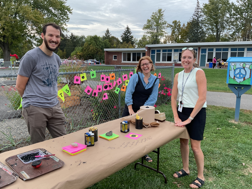 Staff members work a table with fall activities.