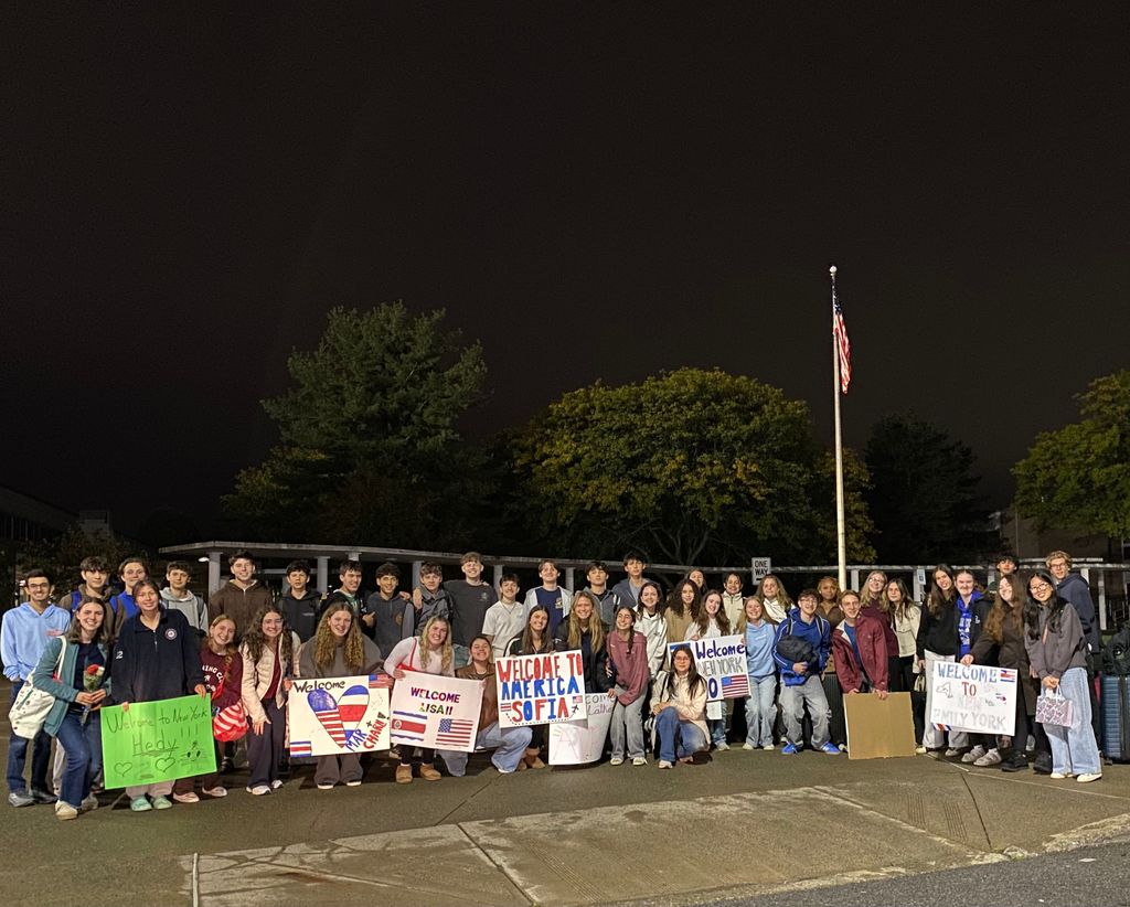 A group of students from Shaker welcome Costa Rican exchange students with welcome signs at their arrival.