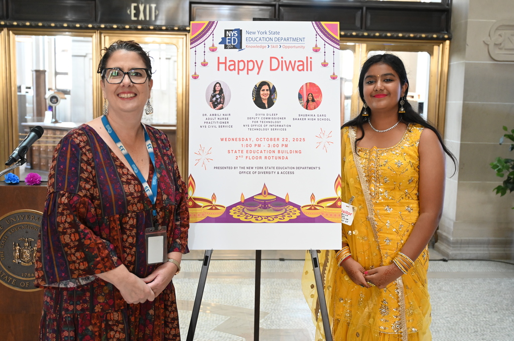 Superintendent Kathleen Skeals poses with freshman Shubhika Garg next to an event poster.