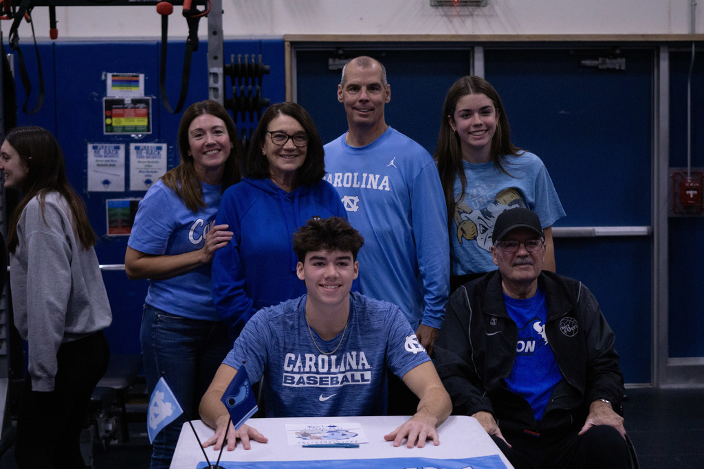 A student and his family members pose after signing his letter of intent.