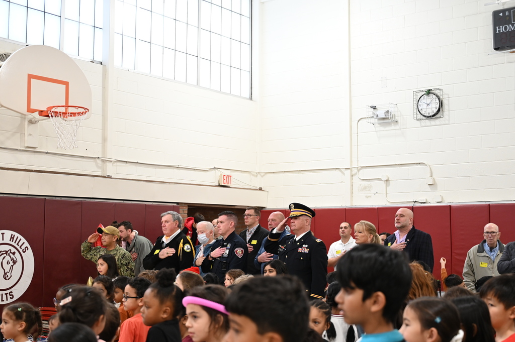 Veterans and active military members listening to Shaker High Band play the Pledge of Allegiance