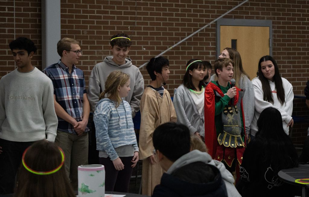 Students stand at the front of the cafeteria to present as part of Martinstag.