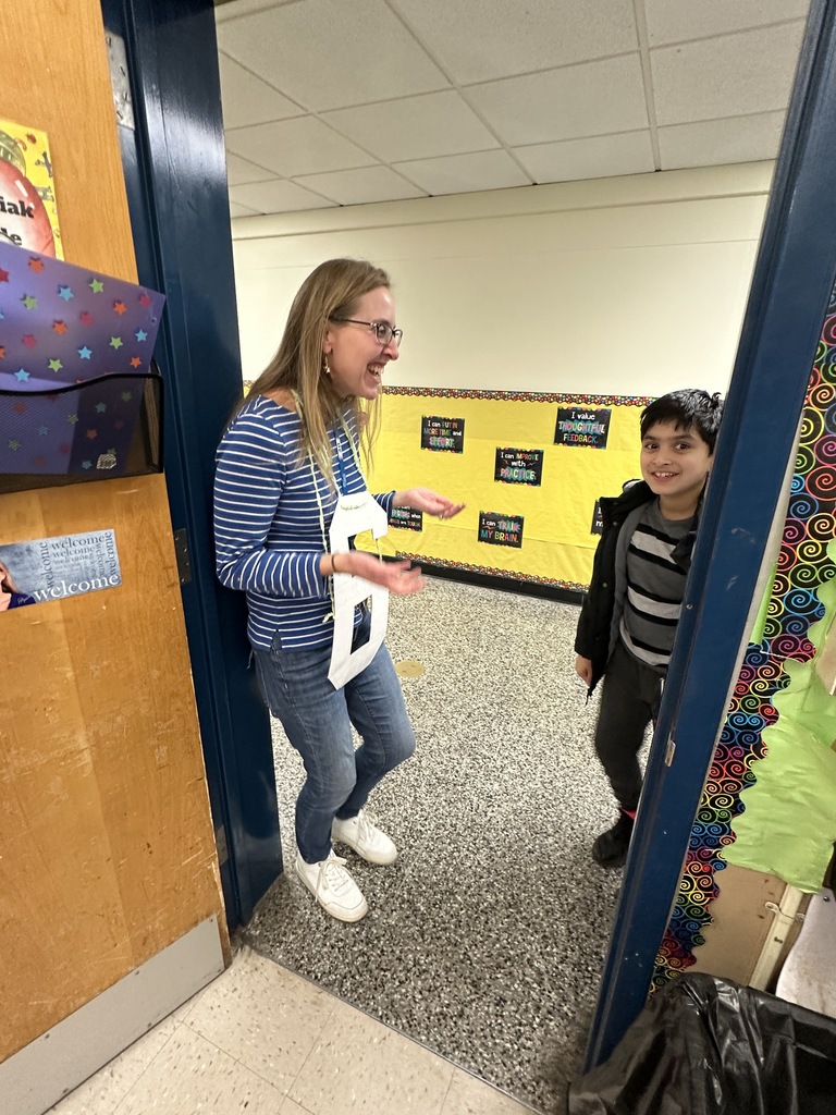 A student is surprised by his teacher wearing a "6" to celebrate the 67th day of school.