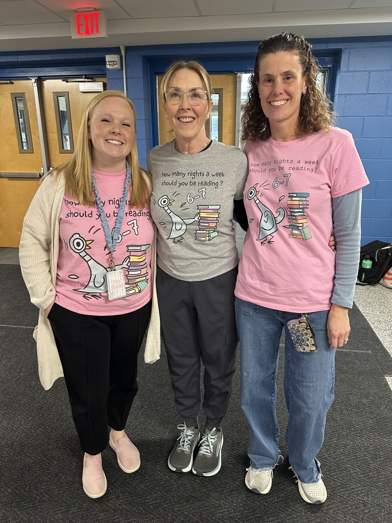 Three staff members pose with t-shirts decorated to celebrate the 67th day of school.