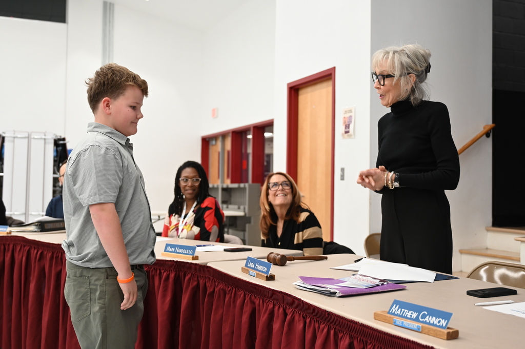 James Nagle speaks to North Colonie Board of Education President Linda Harrison as he receives his Kids Care award.