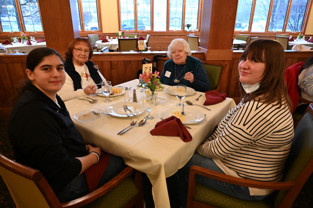 Aliva Retirement community visit with students around the table