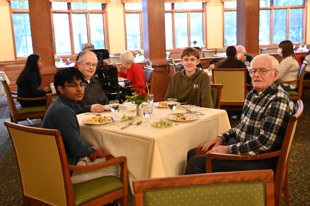 Aliva Retirement community visit with students around the table