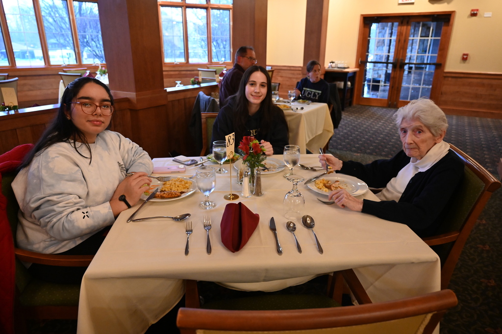 Aliva Retirement community visit with students around the table