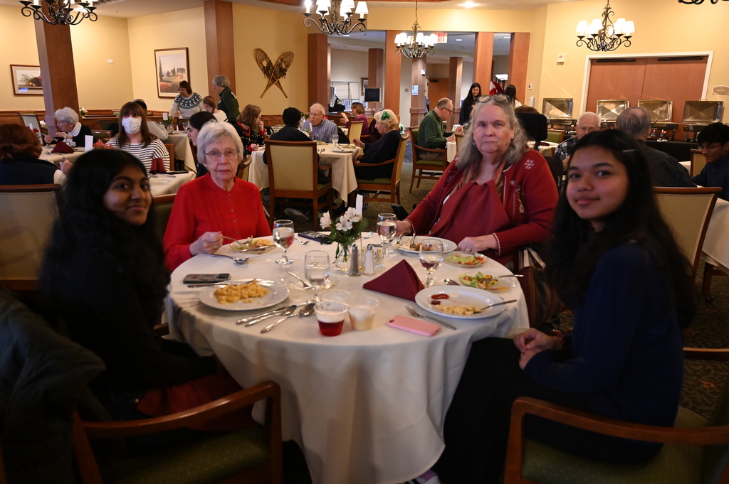 Aliva Retirement community visit with students around the table