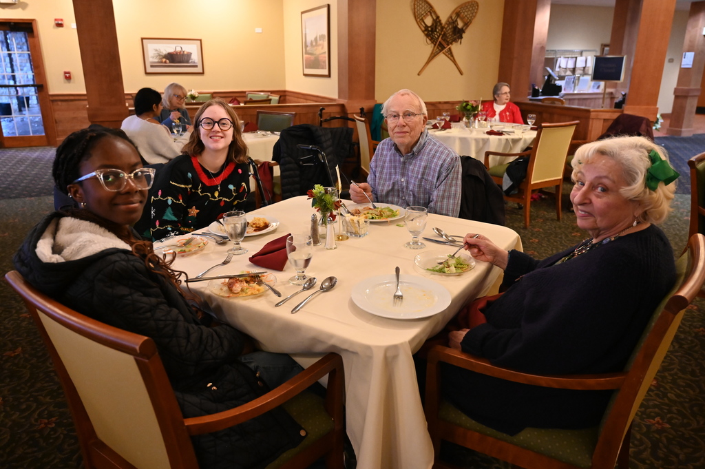 Aliva Retirement community visit with students around the table