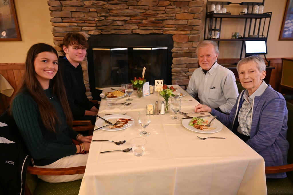 Aliva Retirement community visit with students around the table