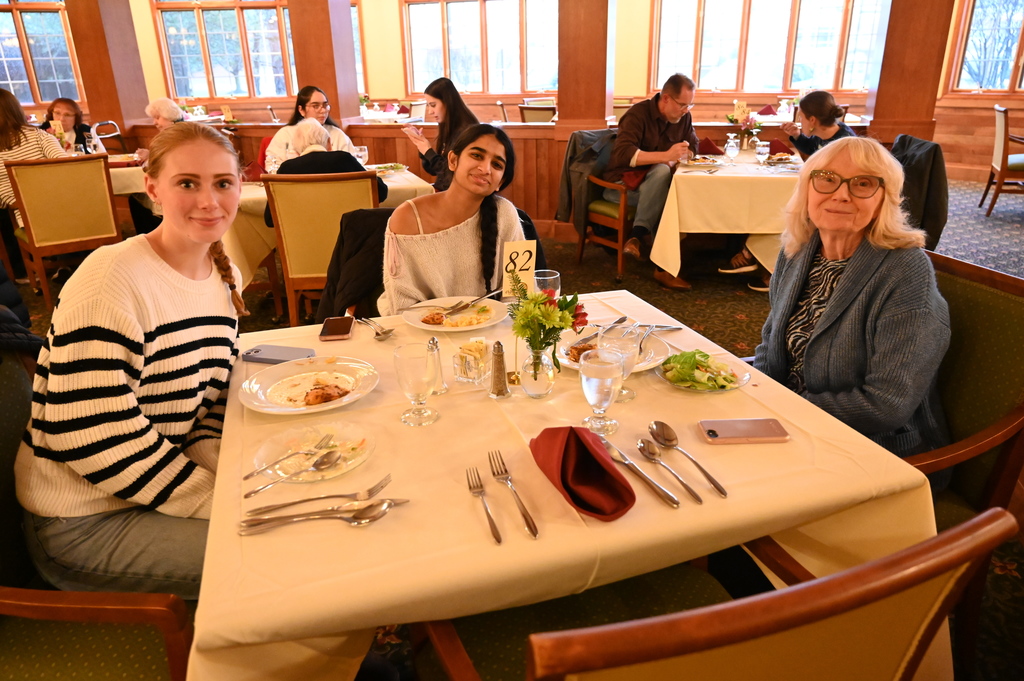 Aliva Retirement community visit with students around the table