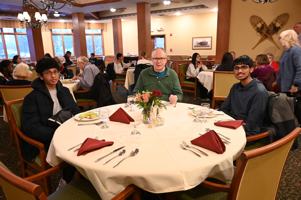Aliva Retirement community visit with students around the table