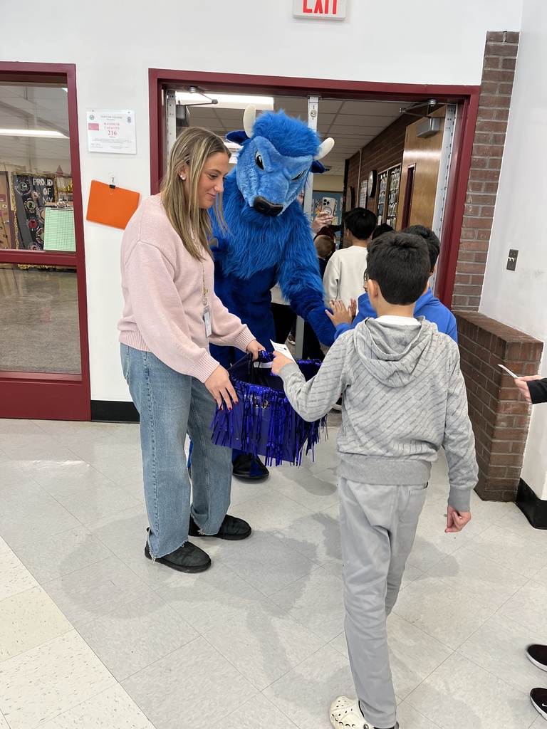 Students cast their vote and high five the Bison mascot as they exit the auditorium.