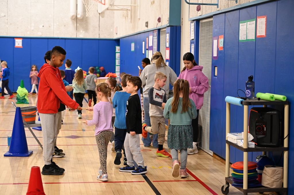 Running Club Students getting popsicle sticks