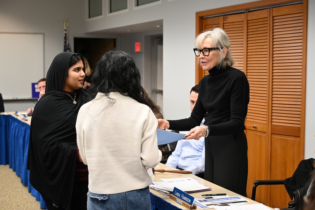 Two January Kids Care recipients receive certificates from NCCSD Board President Linda Harrison.