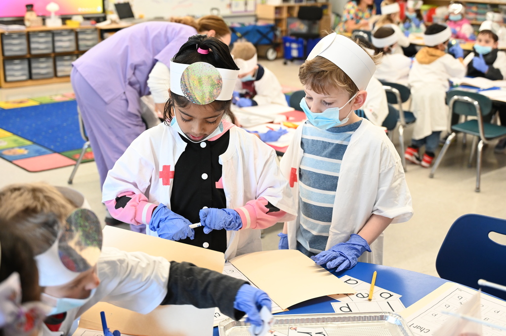 student doctor finding vowels and filling out a chart