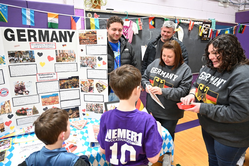 Two students get their passports stamped by teachers in Germany.
