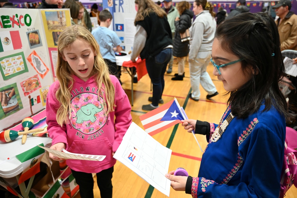 A student stamps another student's passport as she visits Mexico.