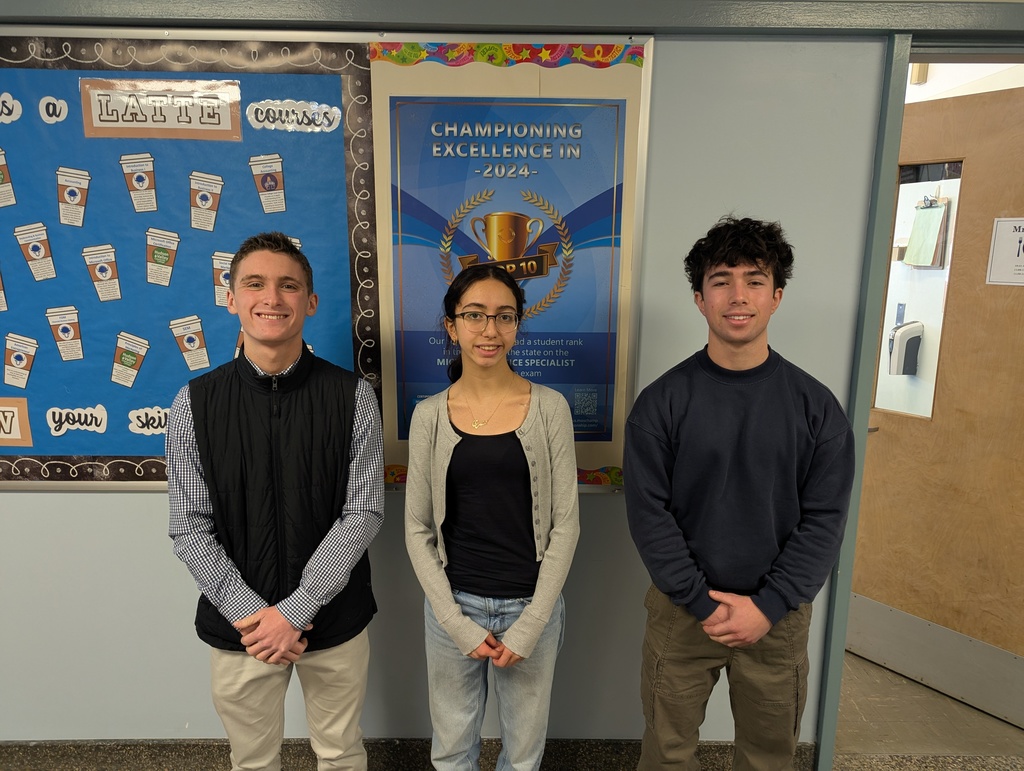 Three students standing in a hallway with Microsoft office certification