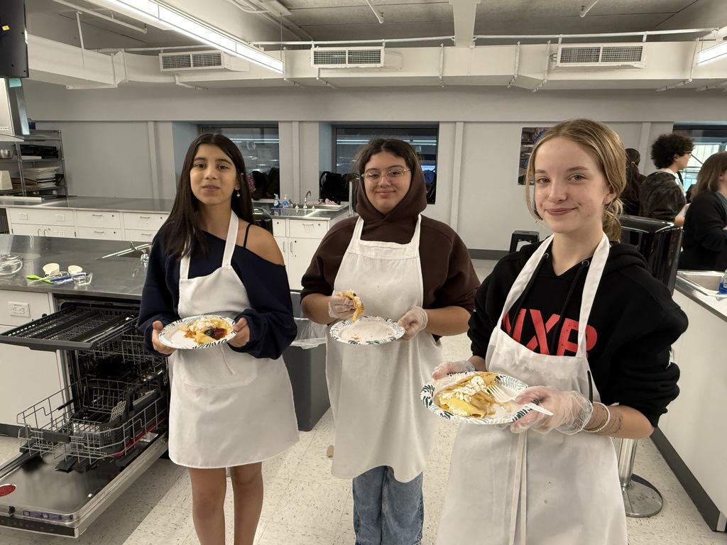 Crepe day at shaker middle school with three students holding the crepes they made