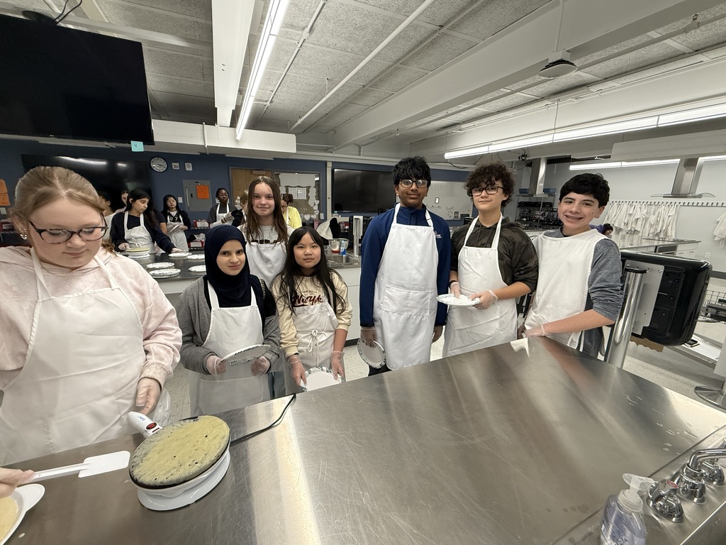 Crepe day at shaker middle school with a student making a crepe and other students watching