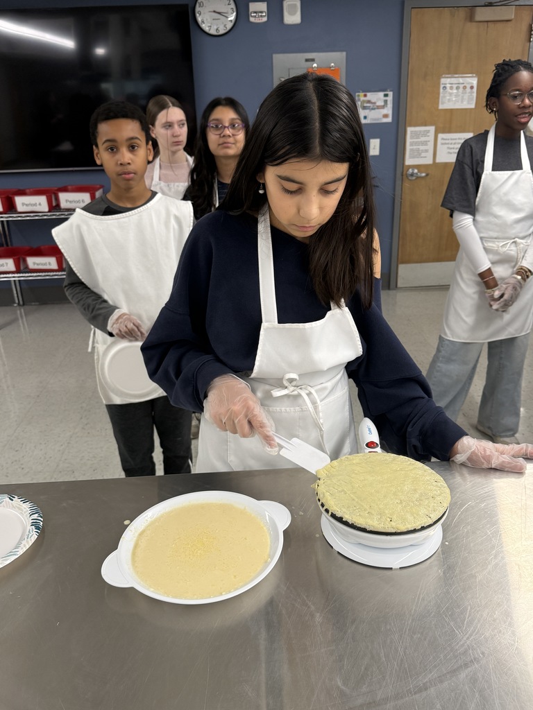 Crepe day at shaker middle school with a student making a crepe and other students watching